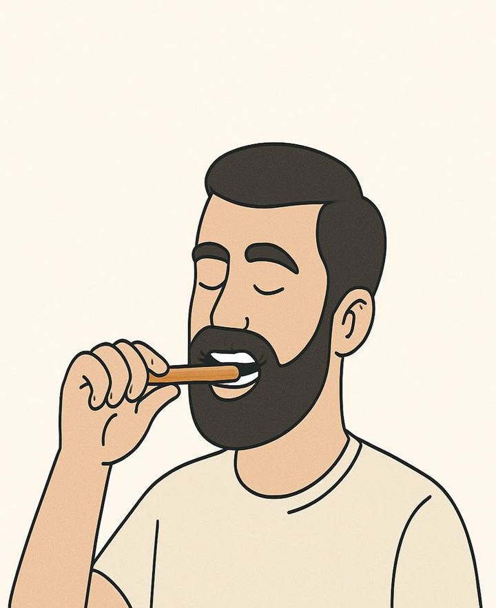 A man using a Miswak stick for natural, chemical-free oral care